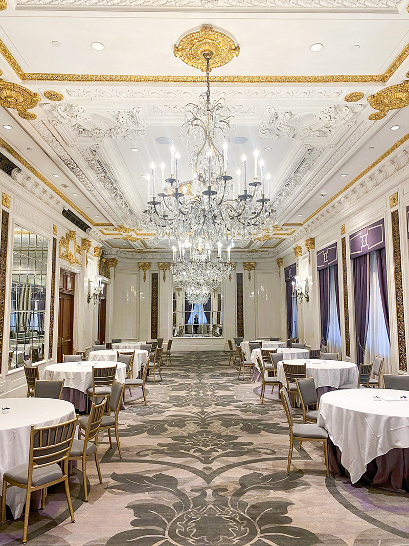 tables set for an event in an elegant ballroom at the St. Regis Hotel in New York City